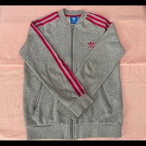 A pink/grey adidas jacket.